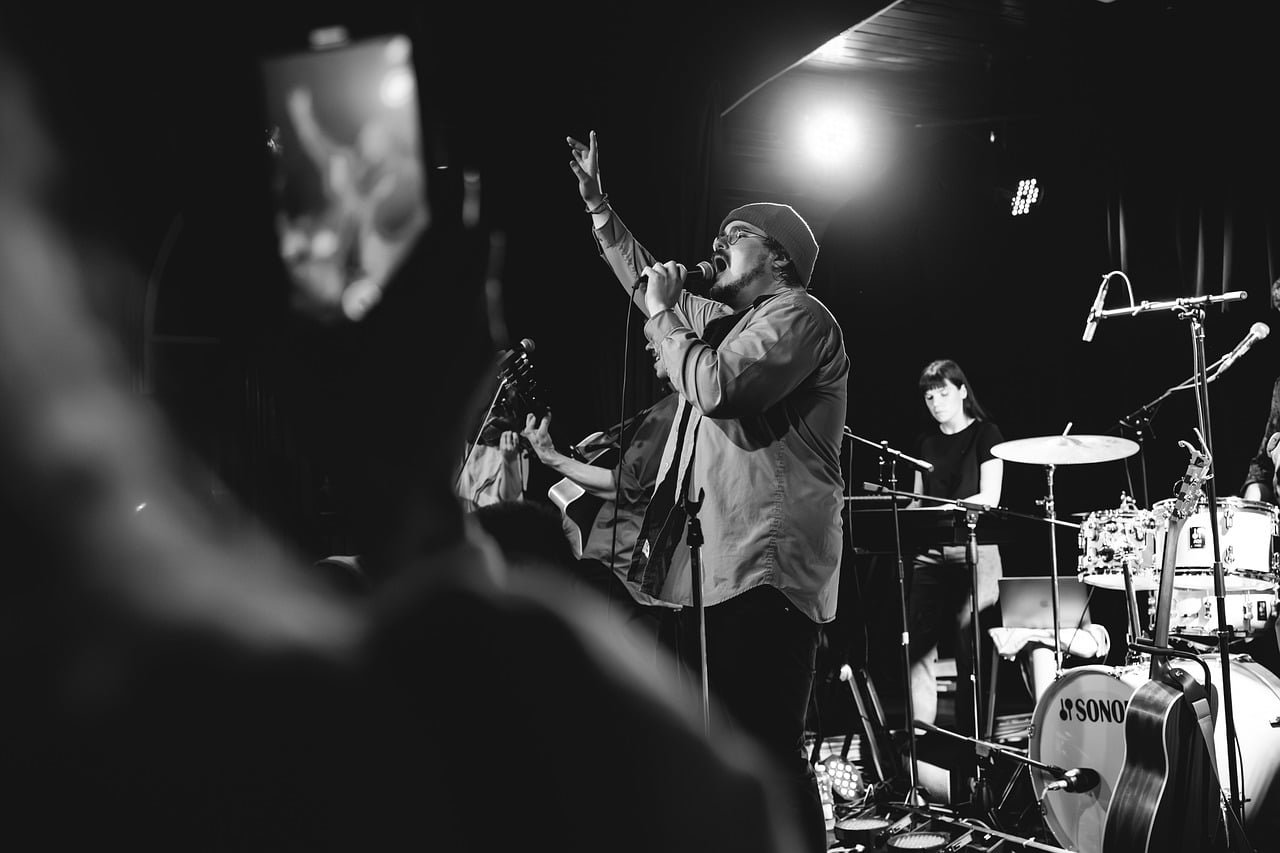 concert, stage, band, singer, drums, guitar, microphone, black and white, live performance, crowd, musicians, musical, lighting, culture, artist, club, audience, emotions, energy, entertainment
